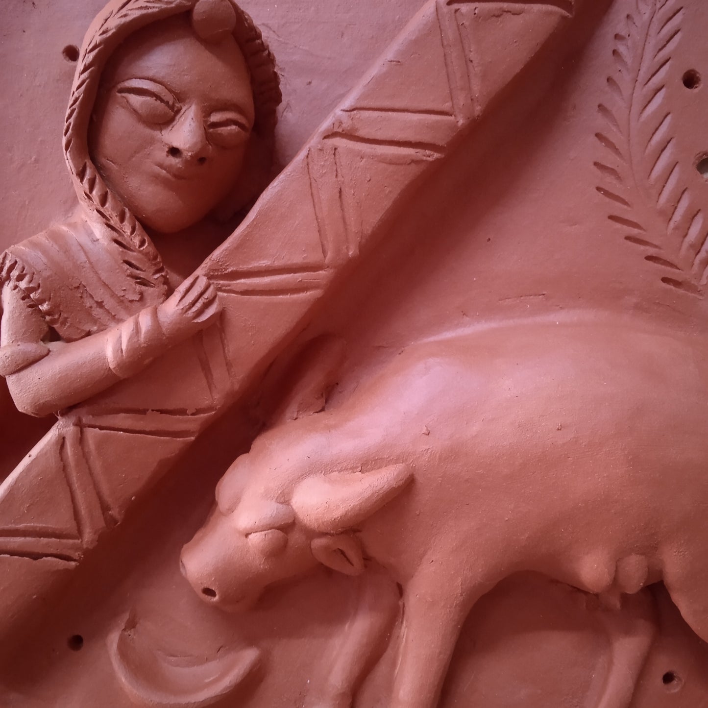 Terracotta woman and a cow