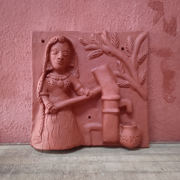 Terracotta woman at hand pump